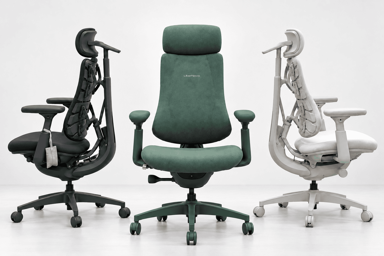 Three ergonomic office chairs in black, green, and white